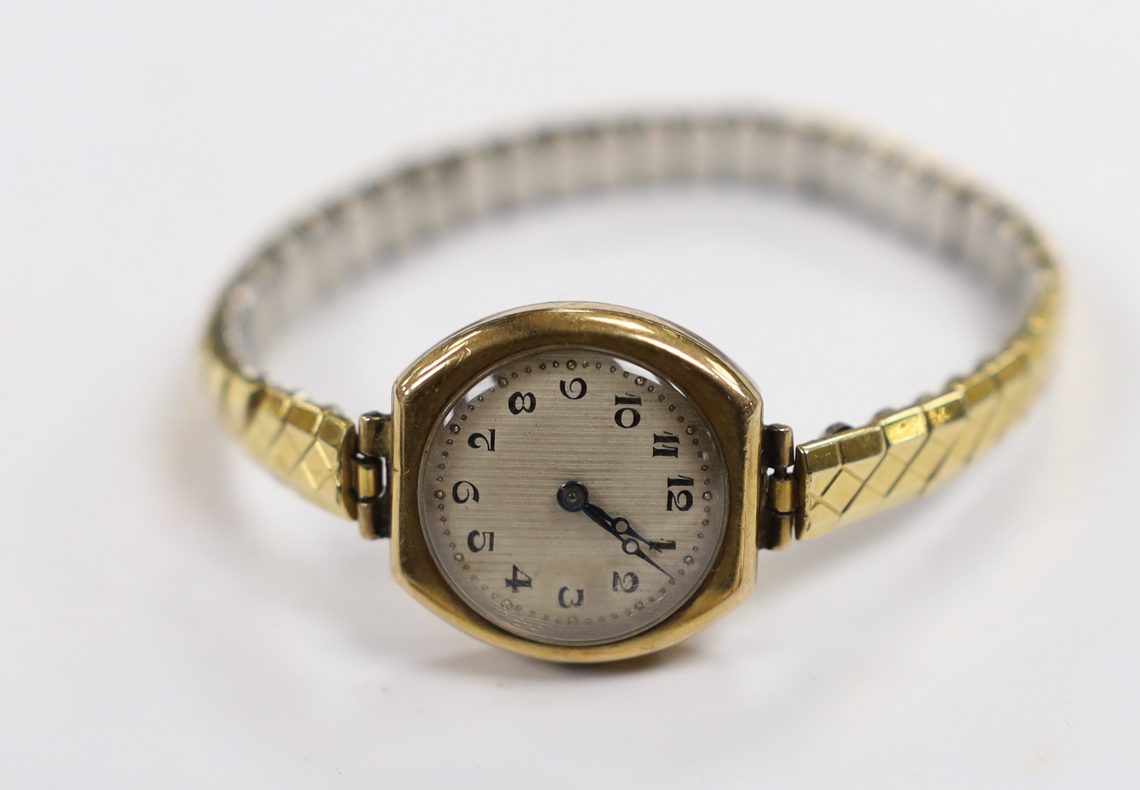 A lady's 18ct gold manual wind wrist watch on a twin fabric strap and three similar 9ct gold wrist watches.